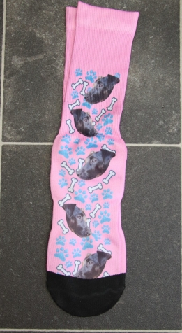 Pink socks with black dog and white bones on it