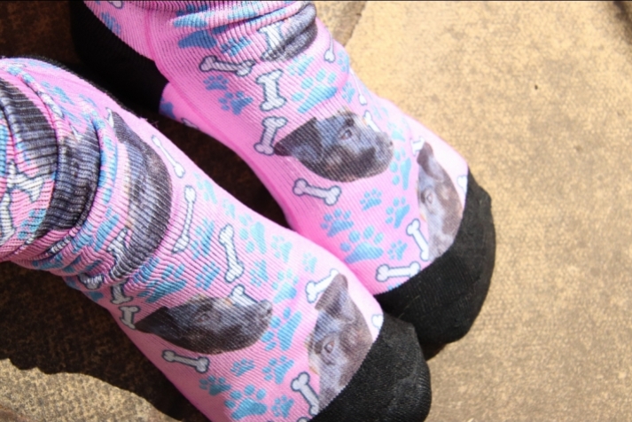 Pink socks with black dog and white bones on