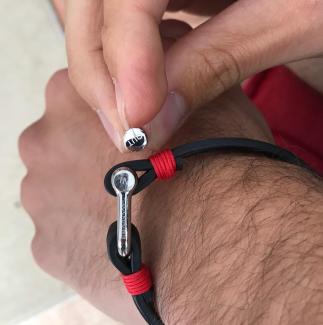 Black leather bracelet with red rope and silver clasps