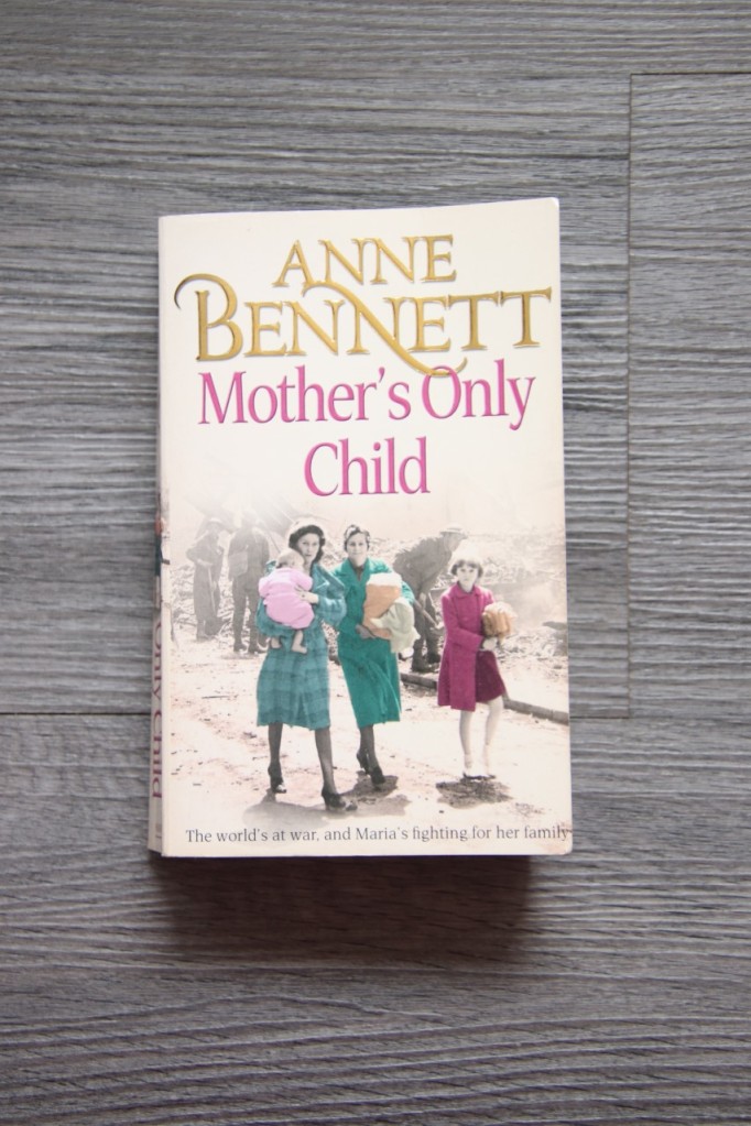 Mother's Only Child front cover showing two women and two children in a bombed out street. 