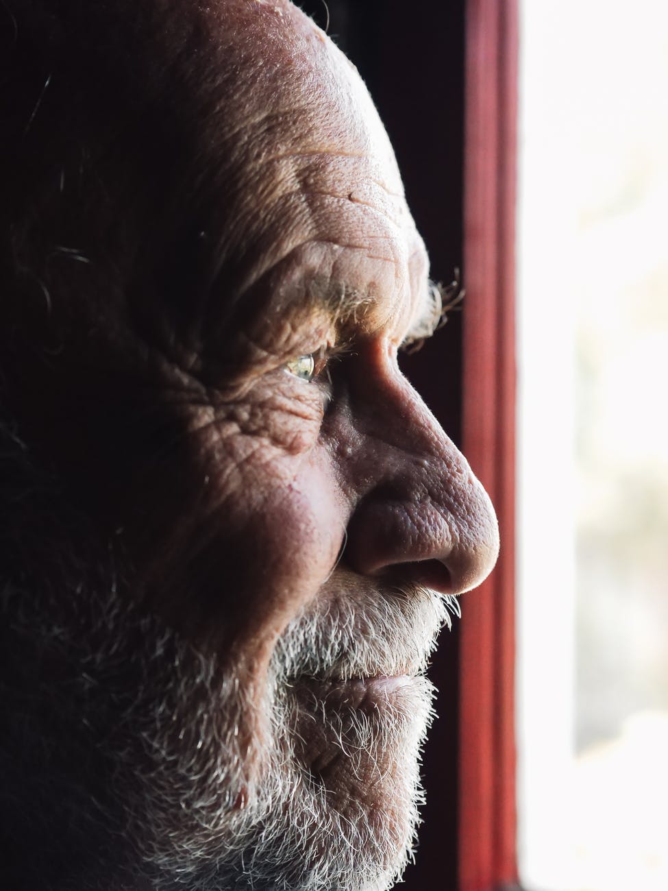 man staring out of window for how to spot the early signs of dementia post. 